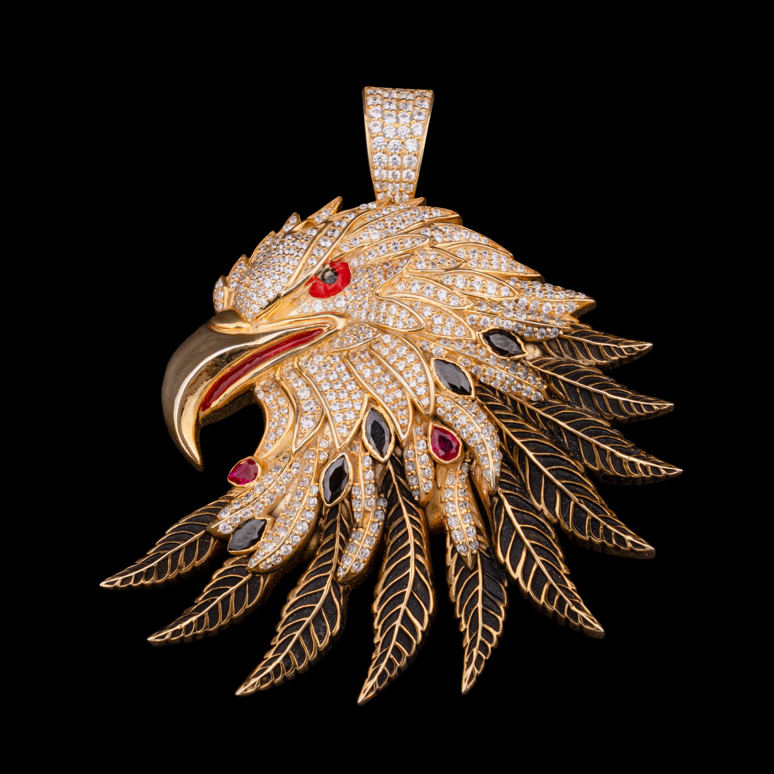 Eagle-head pendant in gold, the crest paved with clear stones and the feathers enamelled black