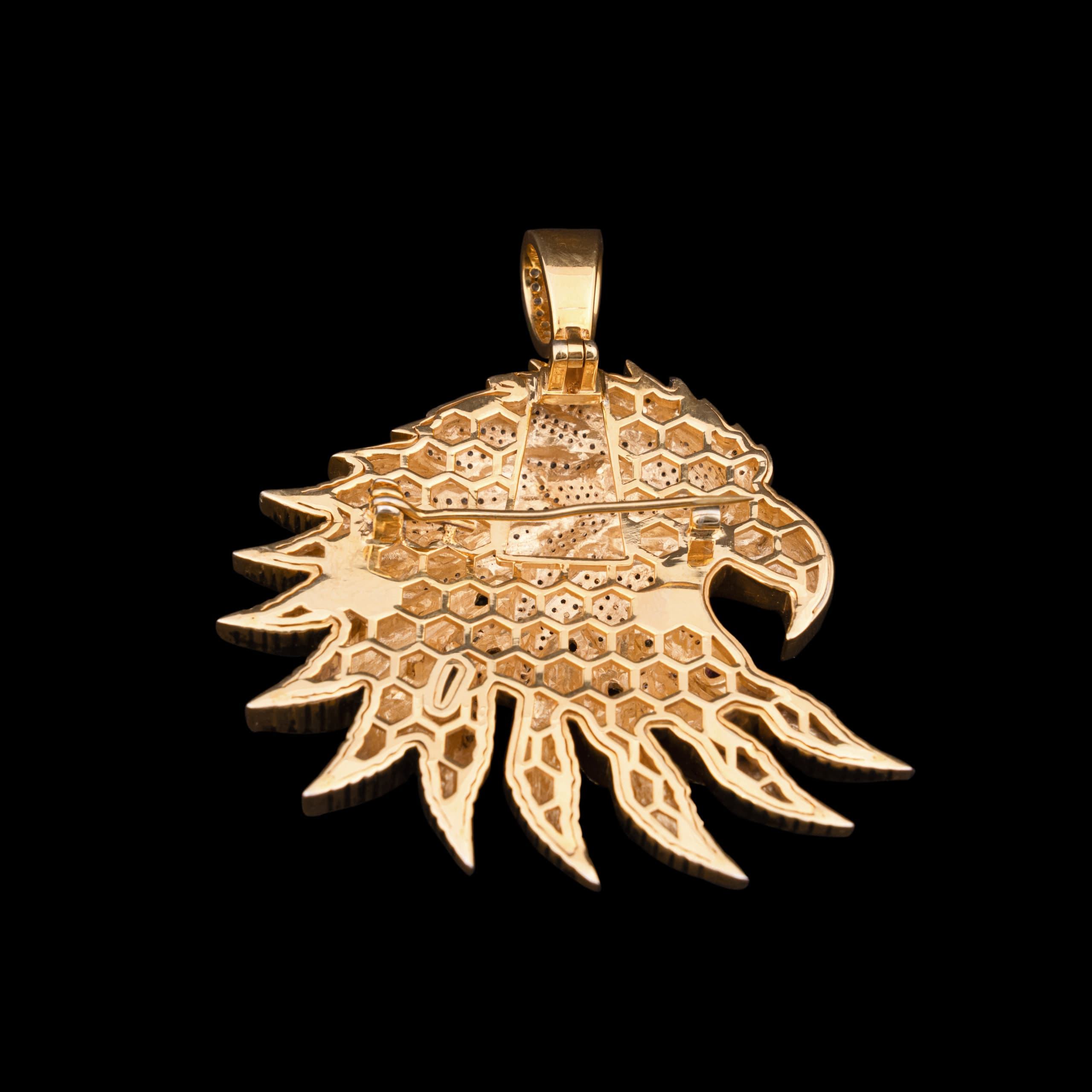 Reverse of the eagle pendant with the bail uppermost, showing the pierced gold backing